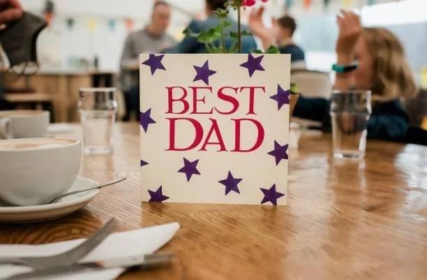 Image of a father's day card displayed on a restaurant table. All the places where dads can eat for less this Father's Day. How to save a penny or two this Father's Day without cutting back