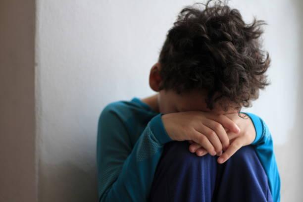Image of a small child looking sad. Child poverty strongly linked to the two-child cap