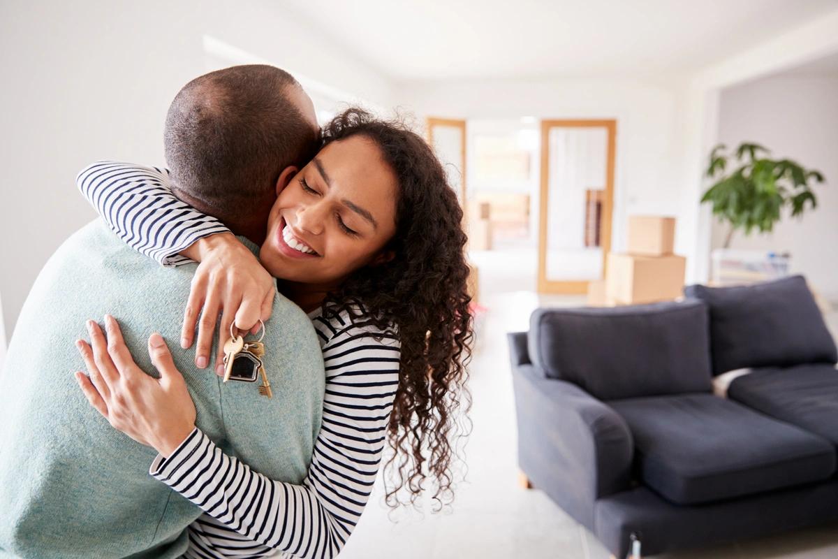 An excited couple move into their first home