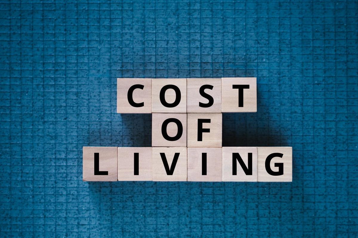 'cost of living' spelt out in wooden blocks