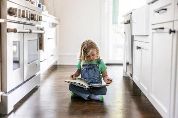 Image of a child sat on the floor reading a book. Free books for everyone inspired by Dolly Parton’s literacy legacy. Dolly Parton's legacy will live on in the millions of children who discovered the joy of reading thanks to her Imagination Library.