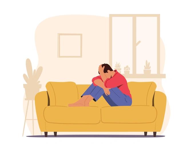 worried man on yellow sofa