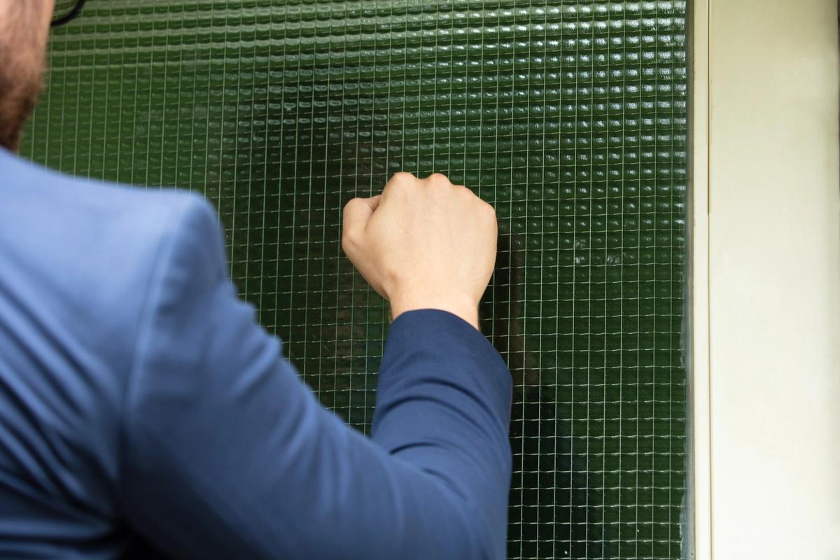 A bailiff knocks at a door