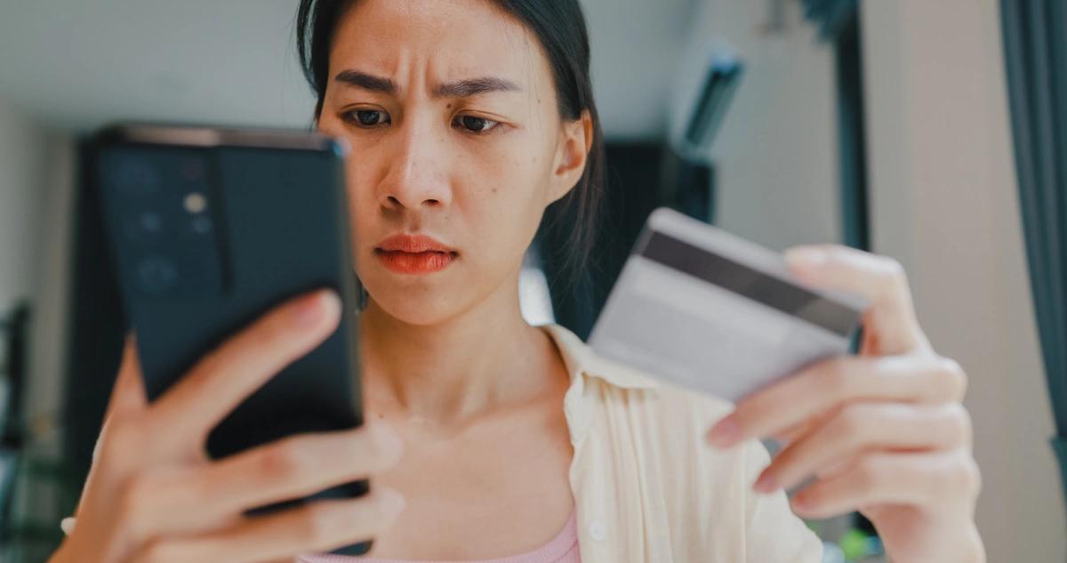 Troubled-looking woman checks her bank account online