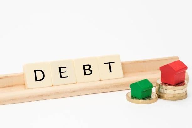 Monopoly money with debt spelt out next to two Monopoly houses. Statute barred debt. What it means, whether it applies to you, and what to do next