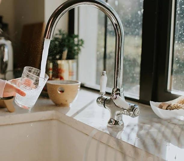 Image of someone running a tap for a cup of water. Why your water use goes up during a heatwave - and what help is available if you’re worried about bills. Everything you need to know about saving on water bills
