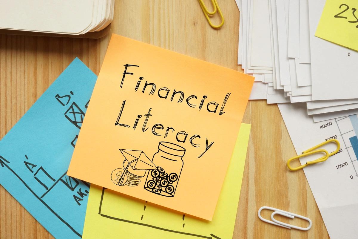 A post-it note with "Financial Literacy" written on it