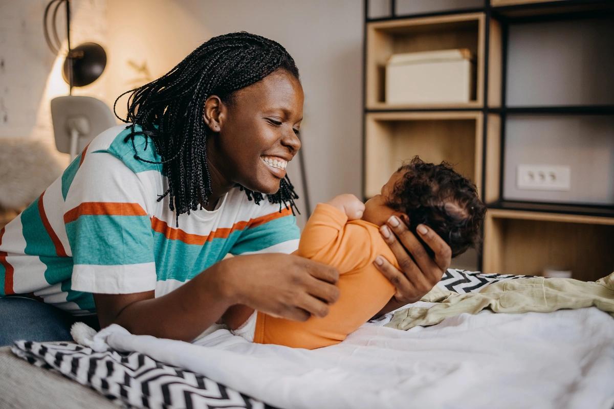 A mother smiling at her new baby