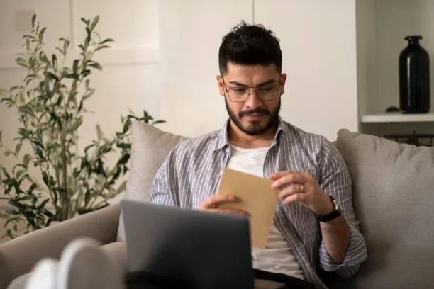 image of a woman checking her paperwork. Thousands could be owed a £90 debt relief order refund. The Insolvency Service has around £450,000 to pay back to people who paid the old DRO fee but never submitted their application