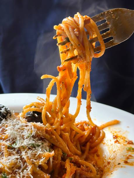 Someone eating a bowl of pasta. Prezzo brings back its 99p pizza and pasta deal – but only for one day!