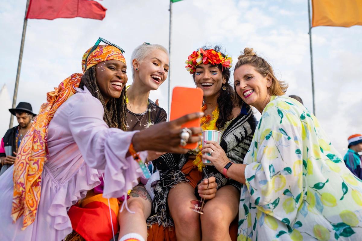 Four women posing for a photograph at a festival