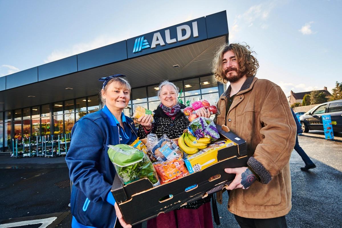 Image of staff outside an Aldi branch handing over food boxes