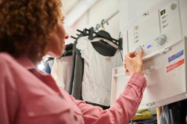 Image of someone turning down their boiler flow temperature. The £100 boiler hack that could keep you cosy all winter