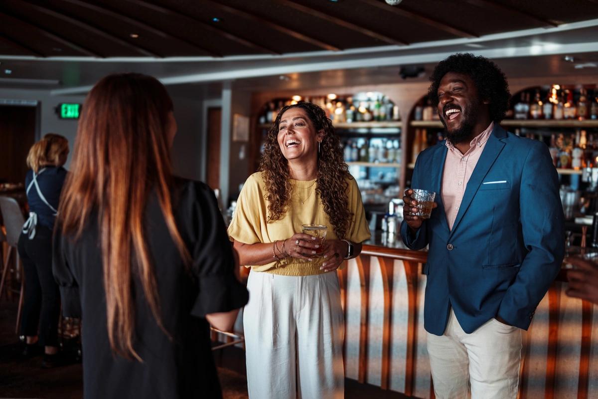 A group of three friends drinking in the pub