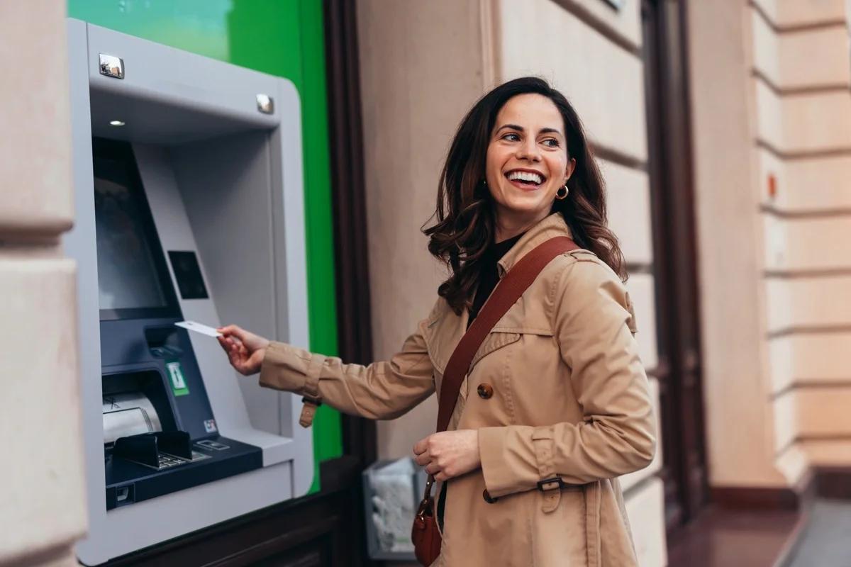 A woman withdraws money from a cashpoint