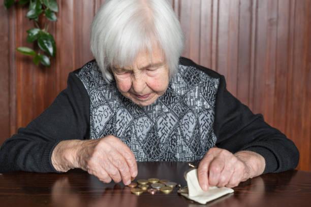 Image of a pensioner counting out money on a table