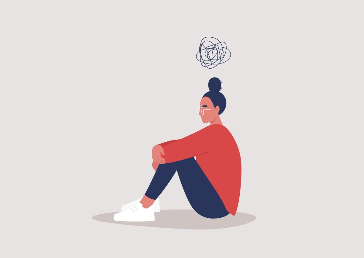 Illustration of a young woman with depression sitting on the floor with a cartoon scribble above her head
