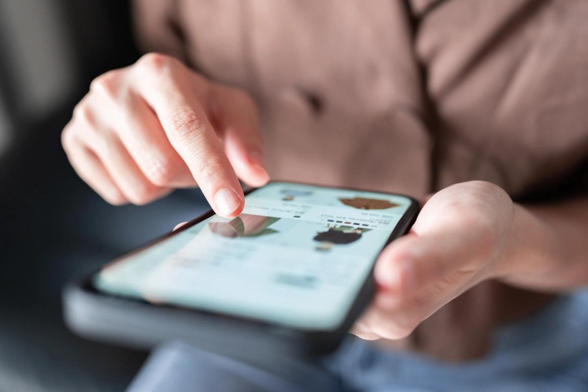 A woman online shopping on her mobile phone