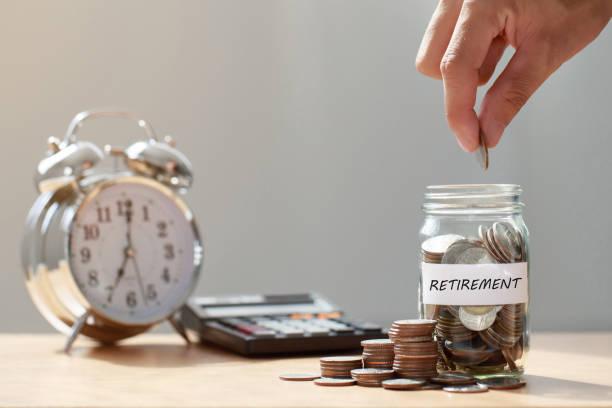 Image of a clock with a calculator and a jar of coins saying retirement. WASPI Women. Compensation for women born in 1950's for pension changes