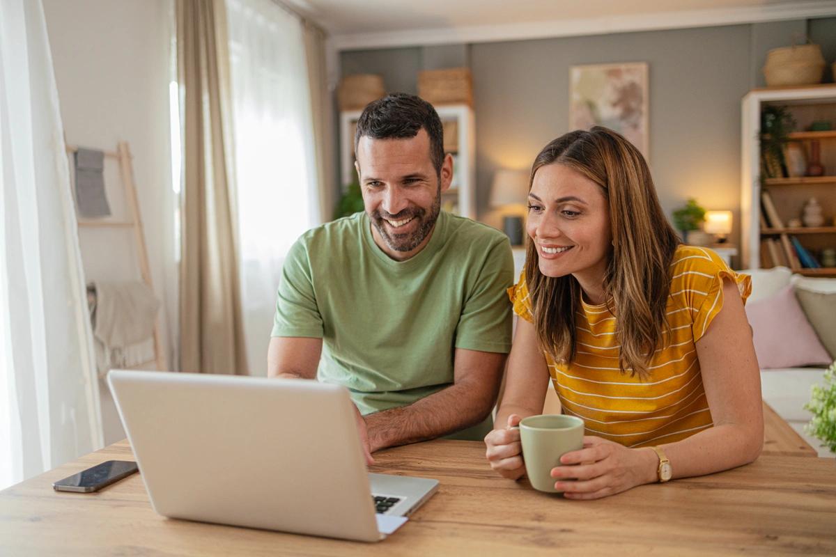 Couple look at remortgaging deals on their laptop