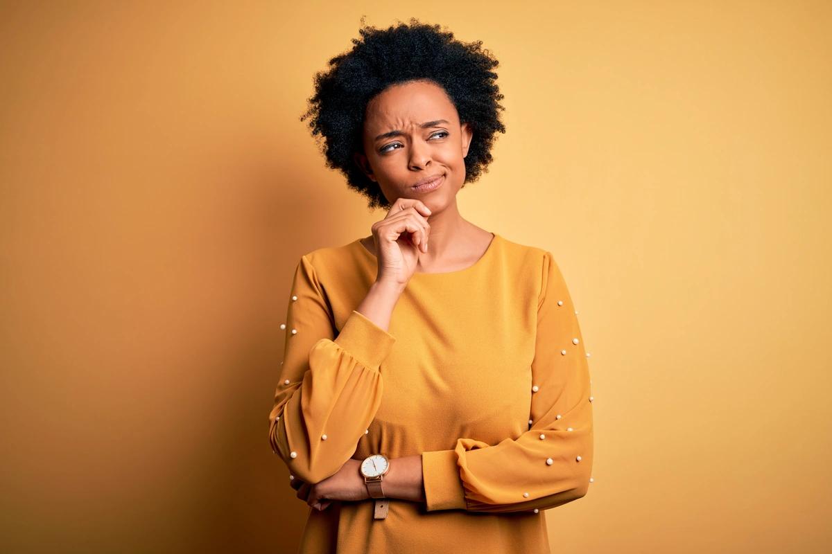 Woman thinking with hand on chin