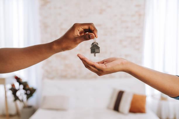 Someone handing a set of keys to a new tenant. Right to buy housing crisis in Leeds. Find out what it means for social housing tenants. Help with social housing