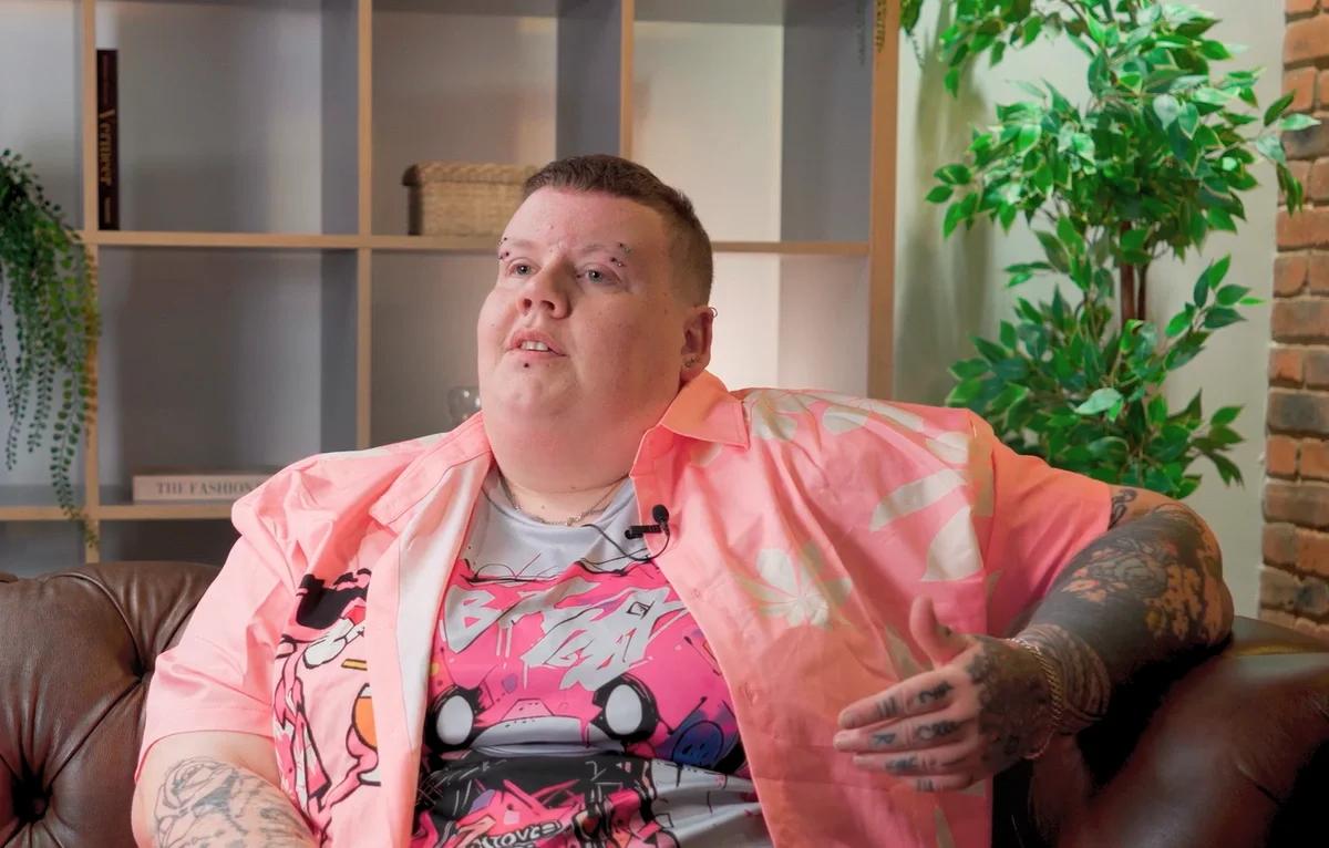 Sam sitting on a sofa talking to Money Wellness about gambling addiction