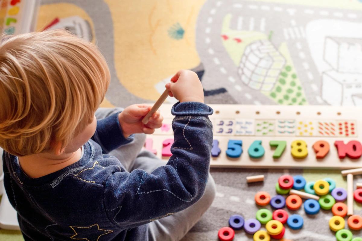 A young child playing at nursery