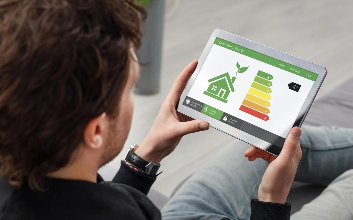 Man looking at home energy efficiency app on his tablet