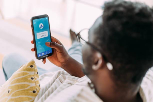 Image of someone looking at their banking app on their mobile. How to cancel unused subscriptions and save. Don't pay for budgeting apps to cancel subscriptions. Do it for free yourself