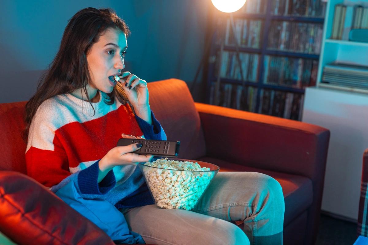 Image of someone watching a film with popcorn. How to save big on cinema tickets this February half term. Free cinema tickets