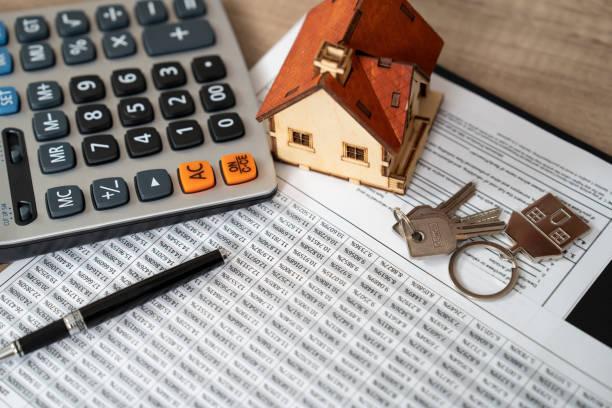 Image of a print out of a monthly household budget with a mini house on top, a set of keys and a calcualtor. New mortgage rules could open doors for some. But if you are in debt, read this first.. Mortgage debt. Struggling with mortgage payments.