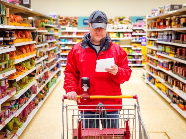 Image of someone looking at their shopping list and looking worried. Consumer confidence falls as households cut back. Here’s what you can do if you’re feeling the squeeze