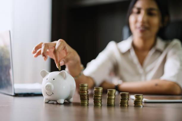 Image of someone saving by putting coins into a piggy banks. Thousands more can now claim free cash from the government. Help to Save scheme extended to help thousands more people