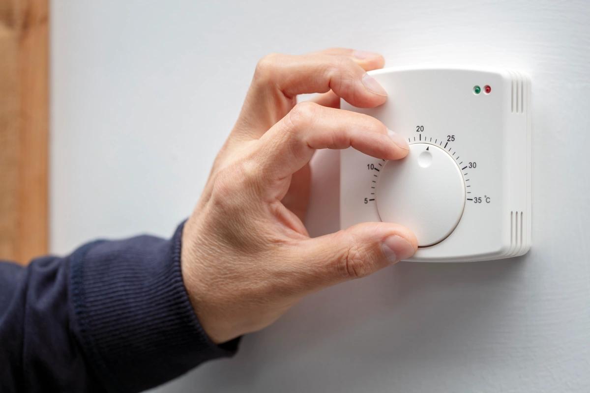 image of someone turning up their thermostat. Rebel Energy goes bust What does it mean for customers especially those with energy debts