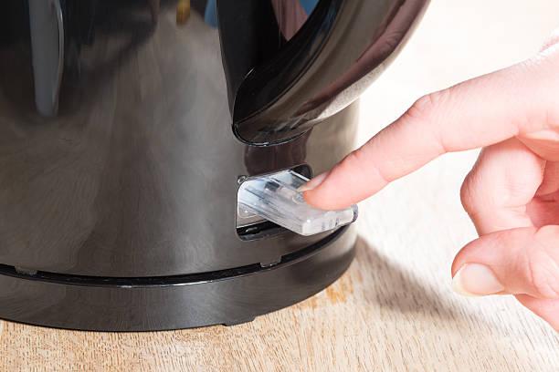Image of a close up of someone turning on a kettle