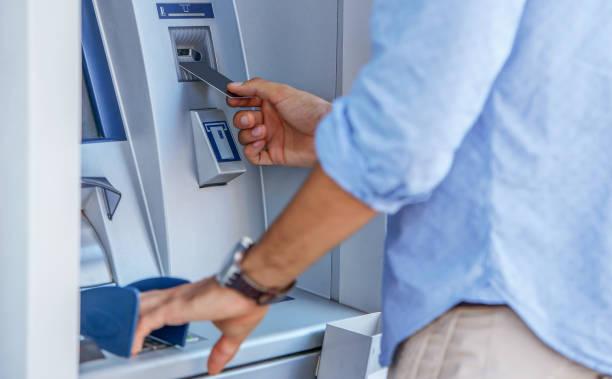 image of a man withdrawing cash from an ATM