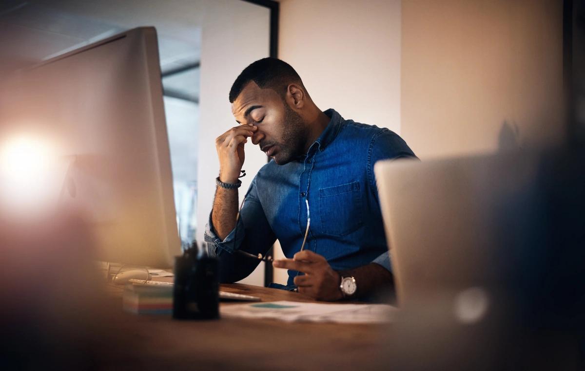 A stressed man at his desk in the office