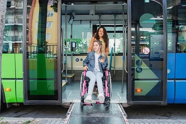Image of a lady in a wheelchair getting off a bus. Disabled people will be able to use their bus passes for free all day - here's when the change starts