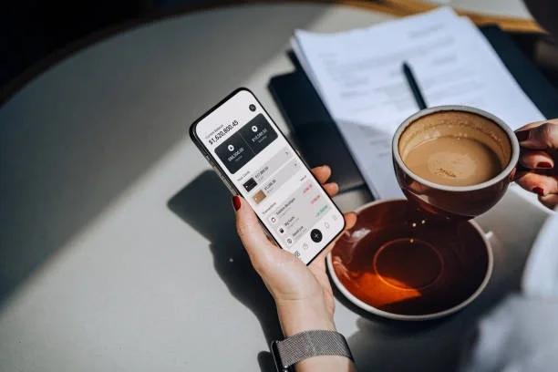 Image of someone looking at their banking app. Six major banks are making it easier to open a bank account