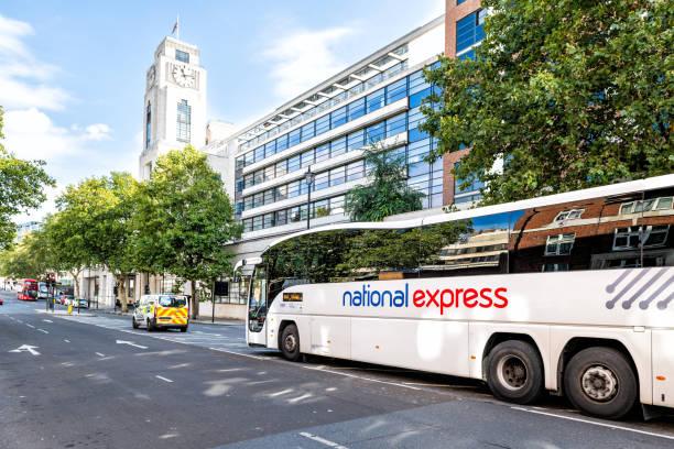 Image of a National Express bus passing a building