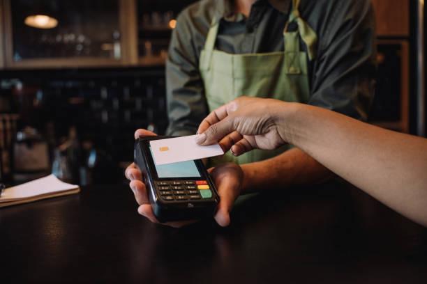 Image of someone paying with a credit card. Could you be owed up to £70 from Mastercard?