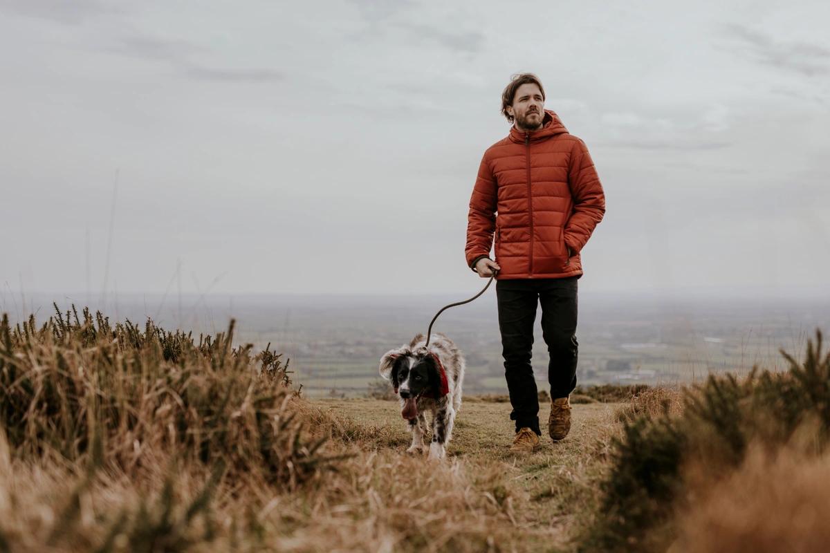 A man taking his dog for a walk