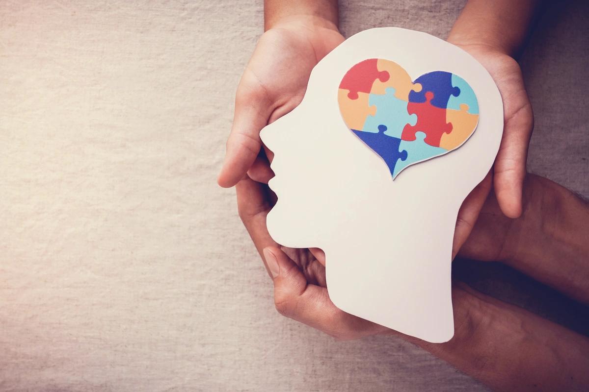 A jigsaw puzzle heart on a wooden head cut-out