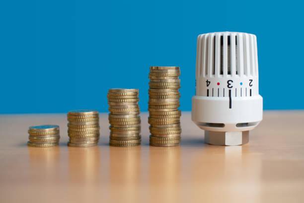 Image of a thermostat with piles of coins around it