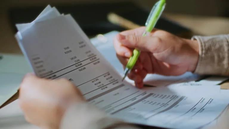 Image of someone going through a utility bill. MPs say vulnerable customers are being let down by water, energy and broadband suppliers. Find out about social tarrifs, hardship schemes and what the governement wants done to protect struggling househo