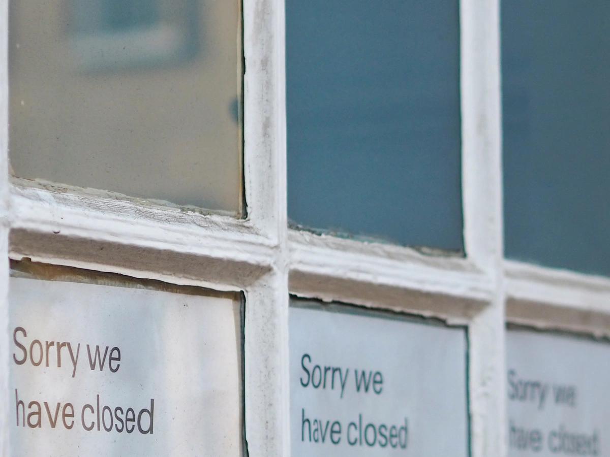 Sorry we have closed signs in bank window