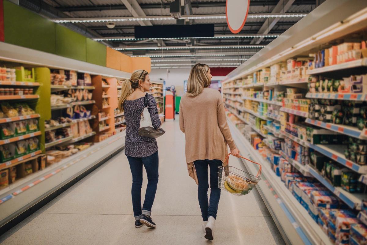 Image of a woman in a supermarket. Aldi gives shoppers a freebie to celebrate its big birthday