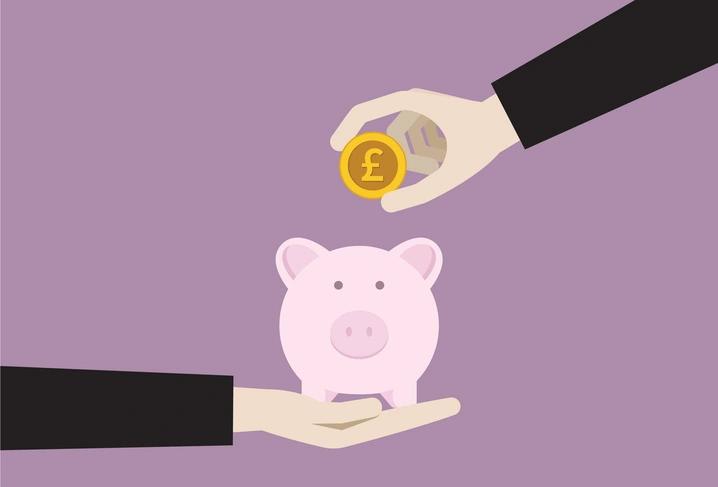 piggybank with a pound being put in it