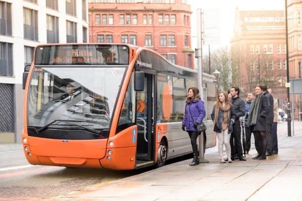 Image of people queuing for a bus. Single bus fares capped at £2 from January 2027 - here's what it means for your money.. Bus fares capped at £2 as government promises more help with the cost of living